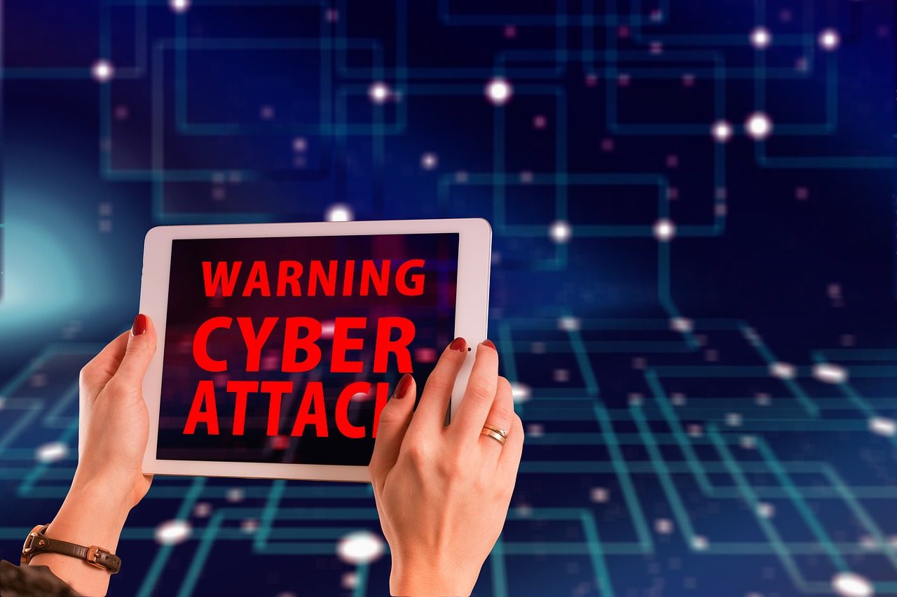 Blog - two hands holding a warning cyber attack sign