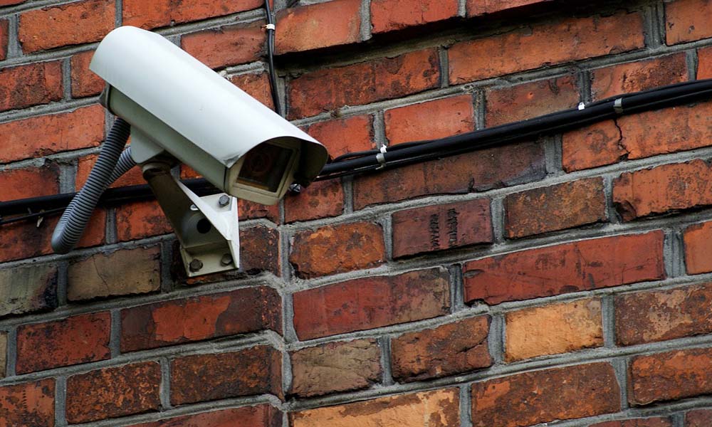 Protecting Your Business During Civil Unrest - Security Camera Mounted On A Brick Wall