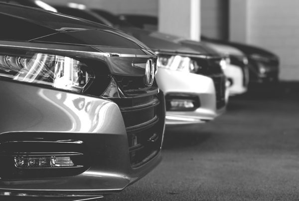 Blog - Grayscale Image of a Line of Shiny Cars in an Indoor Parking Garage