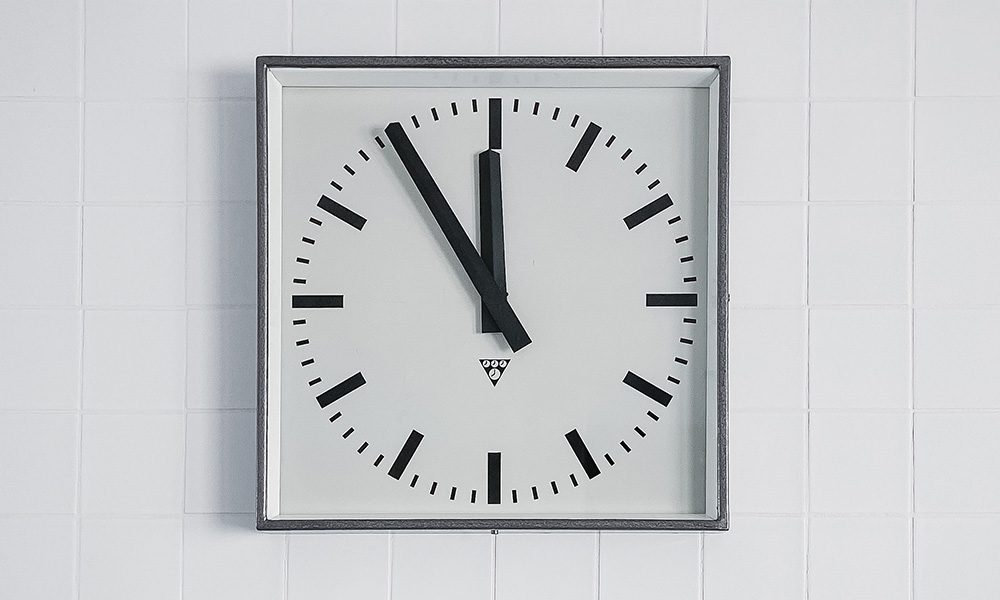 Blog - Work Comp Insights- The First 24 Hours After an Injury - White Clock On A White Brick Wall